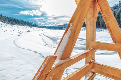 Wooden frame at snowy background . frozen lake scenery