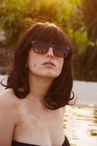 Young woman wearing black bikini in swimming pool