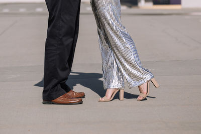 Low section of people walking on street