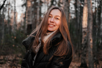 Young woman standing in forest