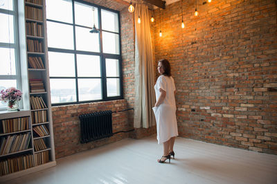 Portrait of woman standing in illuminated room