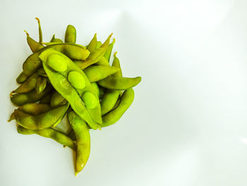 Close-up of green pepper against white background