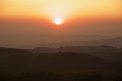 Scenic view of silhouette landscape against sky during sunset