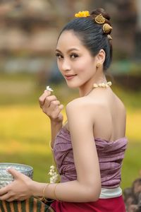 Portrait of young woman holding flower