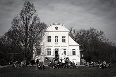 Group of people by building against sky