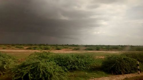 Scenic view of landscape against cloudy sky