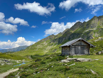 Scenic view of green landscape and mountains against sky