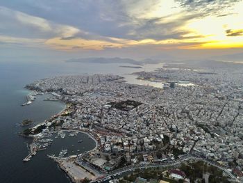 High angle view of illuminated cityscape against sky during sunset