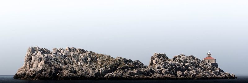 Panoramic view of sea and buildings against clear sky