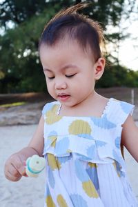 Portrait of cute girl holding baby