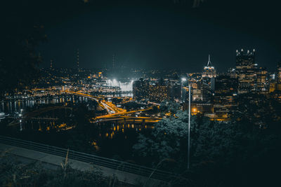 High angle view of city lit up at night