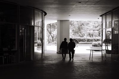 Rear view of couple standing in corridor