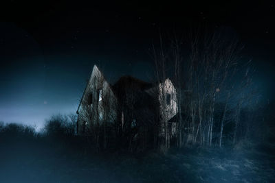 Abandoned building on field against sky at night