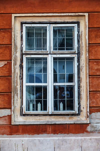 Old vintage wooden window with frames on the wall of the rural house. close-up