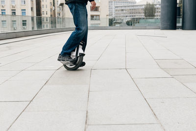 Man riding fast on electric unicycle on city street. mobile portable individual transportation