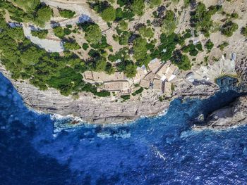 Directly above shot of rock formations by sea