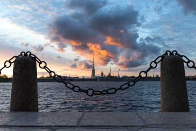 Paul fortress and neva river during dramatic sunset in st. petersburg. view from palace embankment.