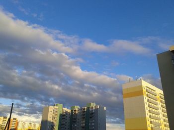 Low angle view of skyscrapers against blue sky