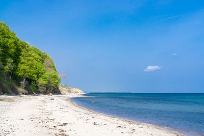 Scenic view of sea against blue sky