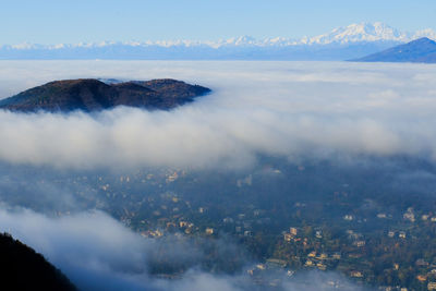 A sea of fog over the city of como and lake como, from a panoramic viewpoint in brunate.