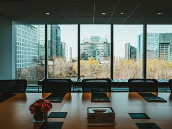 Empty chairs and tables in glass window