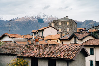 Houses on mountain against sky