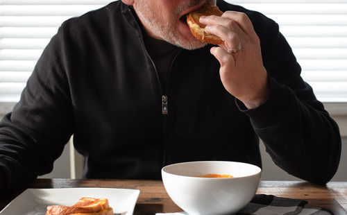 Midsection of man eating food
