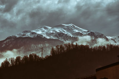 Low angle view of snowcapped mountains against sky