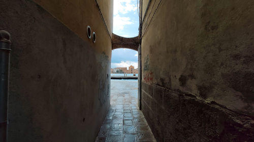 Narrow alley amidst buildings in city