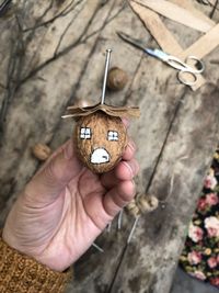 Cropped hand holding christmas decoration