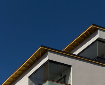 Low angle view of building against clear blue sky