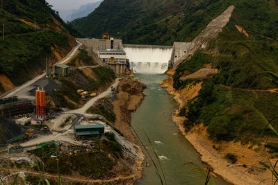 High angle view of dam on road by mountain