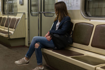 Full length of woman traveling in train