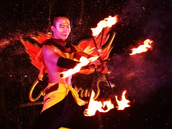 Young man with fire crackers at night