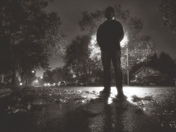 Reflection of woman in water at night