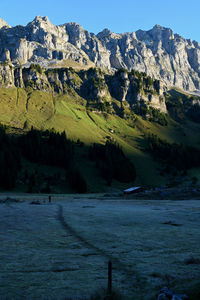 Cold morning in the mountains with sun against blue sky