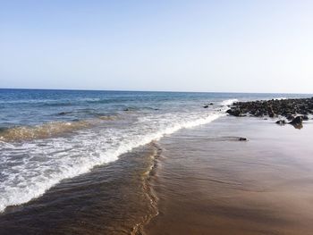 Scenic view of beach against clear sky