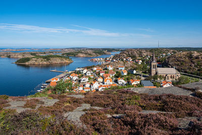 High angle view of townscape by sea against sky