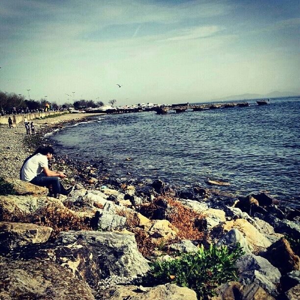 water, sky, rock - object, sea, stone - object, built structure, tranquility, nature, architecture, tranquil scene, shore, beach, scenics, rock, day, stone, beauty in nature, cloud - sky, outdoors, building exterior