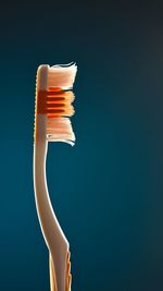Close-up of toothbrush against blue background