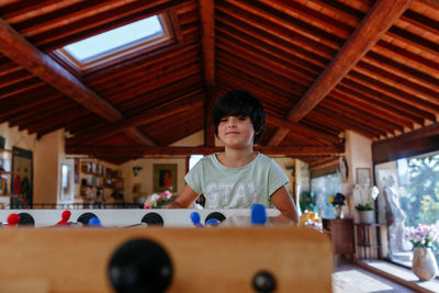 Girl playing table football inside big room