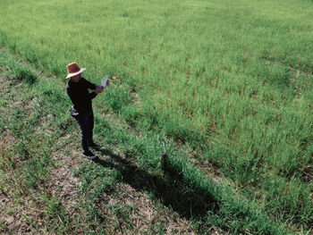 Rear view of man walking on field