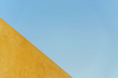 Low angle view of built structure against clear blue sky