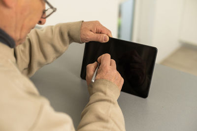 Low section of man using mobile phone