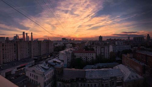 High angle view of buildings against sky during sunset