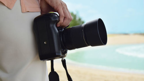 Close-up of hand holding camera