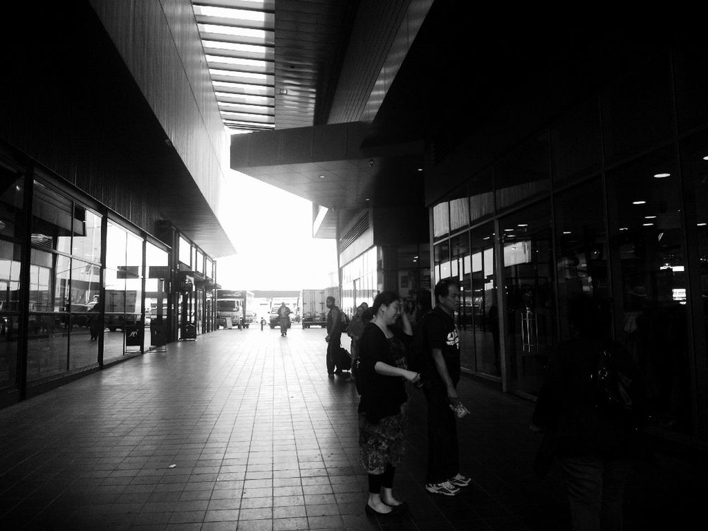 indoors, large group of people, architecture, built structure, men, person, city life, illuminated, lifestyles, city, ceiling, modern, railroad station, flooring, architectural column, walking, group of people, travel, public transportation