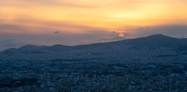 Aerial view of townscape against sky during sunset