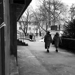 Full length of woman standing on footbridge