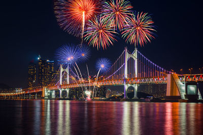 Firework display over river at night